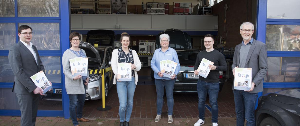 6 Personen vor Eingangstor Halle